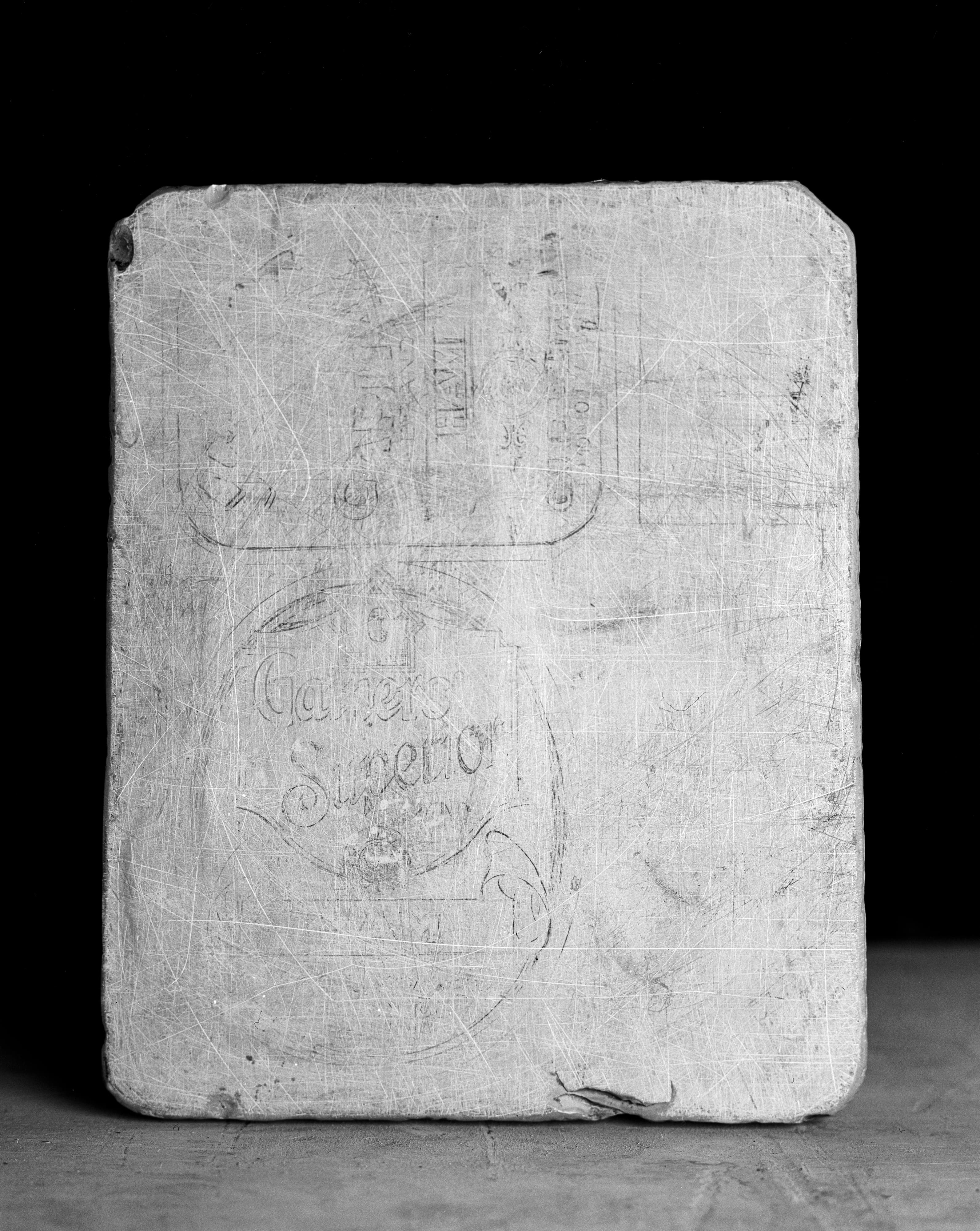 Heavily Scratched Surface Reveals Faint 'Gamers Superior' Imprint