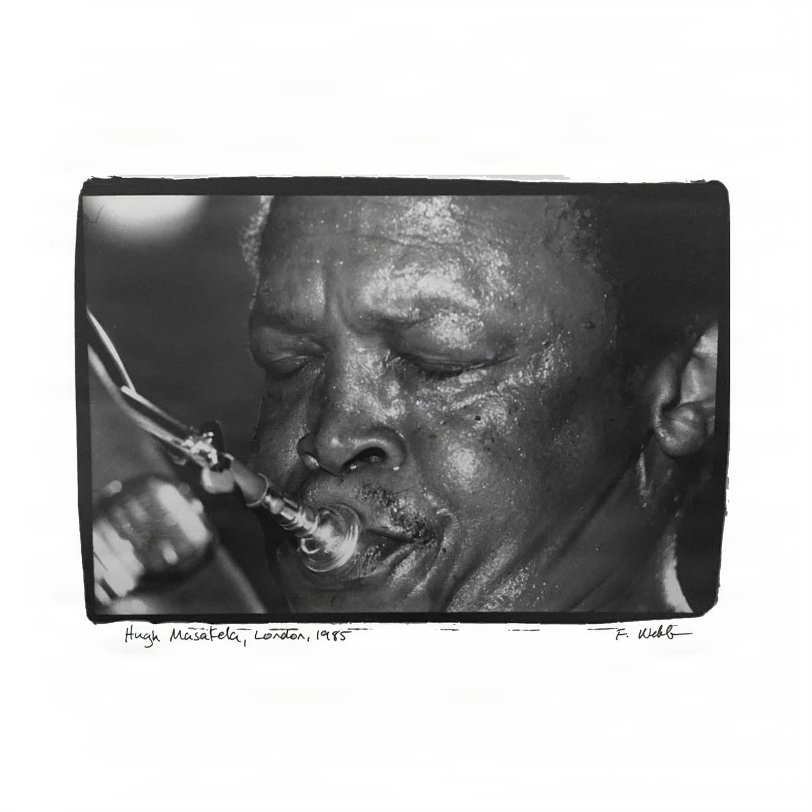 Hugh Masekela performs, eyes closed, playing trumpet in London